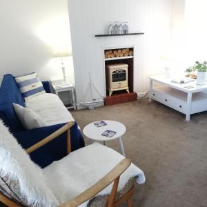 a living room with a couch and a table at Uwch Menai in Y Felinheli