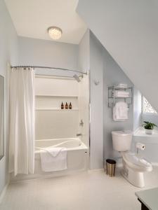 a white bathroom with a tub and a toilet at Pendray Inn and Tea House in Victoria