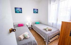 a bedroom with two beds and a window at Chalet El Garxal Riumar Pura Natura in Riumar +29 photos