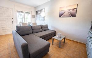 a living room with a couch and a table at Chalet El Garxal Riumar Pura Natura in Riumar