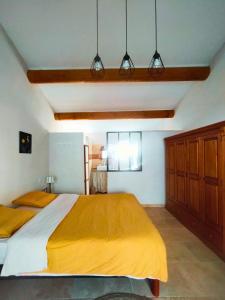 a bedroom with a large bed and three lights at Studio en plein coeur du village in Beaumes-de-Venise