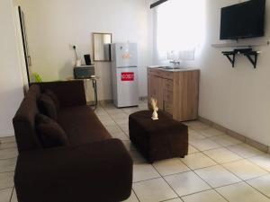 a living room with a couch and a refrigerator at Eliza Guest House in Empangeni