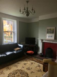 a living room with a couch and a fireplace at No 37 in Bridport