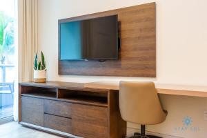 a desk with a television and a chair in a room at NEW LUXURY Beachfront Condo Resort in Hollywood