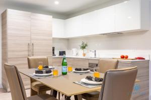 a dining room table and chairs in a kitchen at NEW LUXURY Beachfront Condo Resort in Hollywood