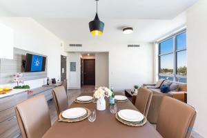 a dining room and living room with a table and chairs at Rooftop Pool- Gym - Hollywood Beach Broad - walk in Hollywood