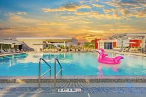 a pool with a pink flamingo in the water at Apartment with Bay View Balcony - Pool - Up To 6 - Gym in Hollywood +67 photos