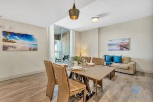 a dining room and living room with a table and chairs at Apartment with Bay View Balcony - Pool - Up To 6 - Gym in Hollywood