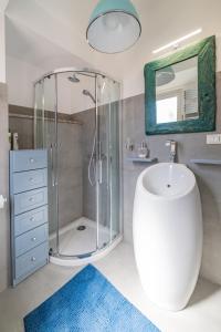 a bathroom with a shower and a sink and a mirror at Cascabella Taormina in Taormina +35 photos