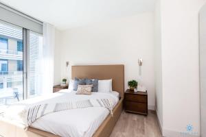 a bedroom with a large bed and a large window at NEW Beachfront Condo ROOFTOP infinity POOL in Hollywood