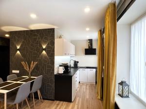 a kitchen and dining room with a table and chairs at Fashion Apartment in Narva