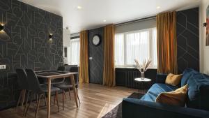 a living room with a blue couch and a table at Fashion Apartment in Narva +26 photos