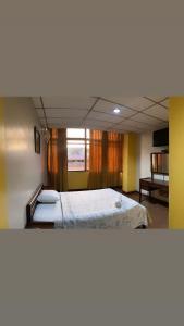 Postel nebo postele na pokoji v ubytování Hotel Andes Inn + 7 fotografií