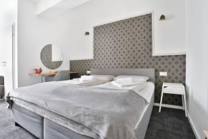 a bedroom with a large bed and a wall at Stilvolle Apartments in Bonn I home2share in Bonn