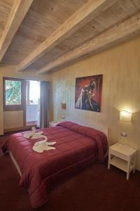 a bedroom with a large bed with a red blanket at Bel Sole Guest House in Civitavecchia