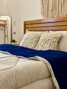 a bed with a blue and white blanket on it at 3-Cozy Bedroom Haven l Free Horseback Tours in Cairo