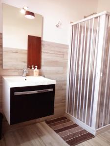 a bathroom with a sink and a mirror at RoofTop Home Stagnone in Marsala