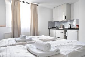 two beds in a room with towels on them at Stilvolle Apartments in Bonn I home2share in Bonn