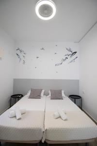 a bedroom with two beds and a white ceiling at Congresos Flat by Concept Flats in Valencia