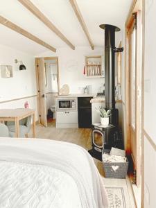 a kitchen with a wood stove in a room at Hidden Gem Luxury Shepherd Hut - Pea Pod in Wimbish