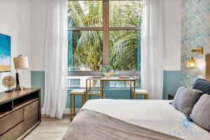 a bedroom with a bed and a large window at Best Stay - Rooftop Pool & Hot Tub - Hollywood Beach in Hollywood