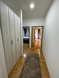 a room with a hallway with wooden floors and cabinets at Oasis of Peace in Trebinje