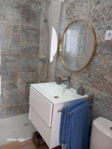 a bathroom with a white sink and a mirror at O Quintal Guesthouse in Carvoeiro