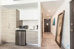 a kitchen with a sink and a microwave at Amazing Pool - Gym - Hot Tub - Near Beach in Hollywood