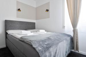 a bed with white sheets and pillows in a bedroom at Stilvolle Apartments in Bonn I home2share in Bonn