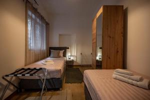 a bedroom with two beds and a mirror at Apartments Portarata in Pula