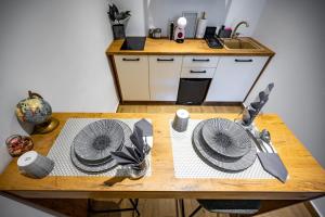 a wooden table with plates on it in a kitchen at Apartments Portarata in Pula