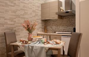 a kitchen with a table with food on it at Domus Cuomo B&B in Nocera Inferiore