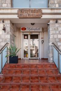 a entrance to a restaurant with a sign on a building at Mila & Aleksandr Apartments in Budva