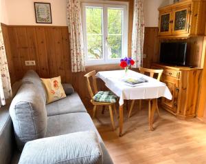 a living room with a table and a couch at Haus Mangard in Sankt Gallenkirch