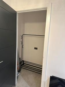 a room with a closet with a metal gate at Newark House Premium Apartments by DH ApartHotels in Peterborough