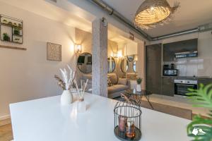 a living room with a white table and a couch at MBA - Splendide Appartement Proche Montmartre in Paris
