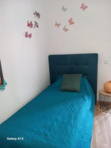 a bedroom with a blue bed with a blue comforter at O Quintal Guesthouse in Carvoeiro