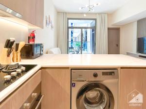 a kitchen with a washing machine in a kitchen at Stunning 1Bedroom with Balcony in Studio City in Dubai