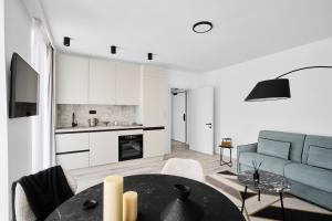 a living room with a table and a couch at Collect Residence in Budapest