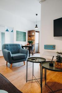 a living room with a blue couch and two tables at The Loft-Old Town Miracle Home in Bucharest