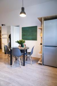 a dining room with a table and a refrigerator at The Loft-Old Town Miracle Home in Bucharest