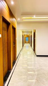 a hallway in a building with a long corridor at DEV RESIDENCY ( A UNIT OF THE ELEGANCE ) in Varanasi
