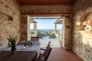 a dining room with a table and a view of the ocean at Villa Lydia in Parikia