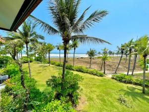 a view of the beach from the balcony of a resort at Abogo Champa Villa Beach Da Nang in Da Nang