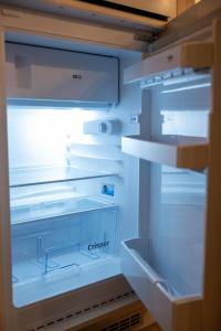 an empty refrigerator with its door open with the door open at Little Vienna Silver Apartment in Varaždin