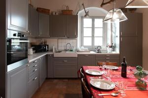 a kitchen with a table with a red table cloth at Il Marrubio in Vicchio
