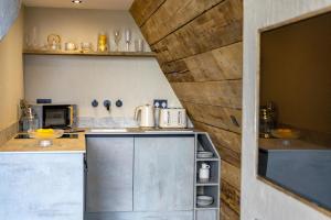 a kitchen with a counter top with a microwave at The Tri-Pod in Llanarth