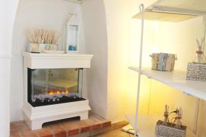 a fireplace in a living room with a fire place at Circeii in San Felice Circeo