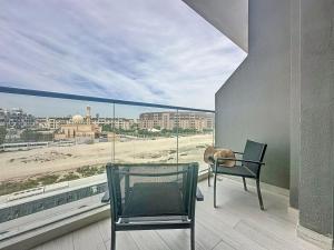 杜拜的住宿－Key View - Laya Heights，设有带桌椅的阳台,享有海滩美景