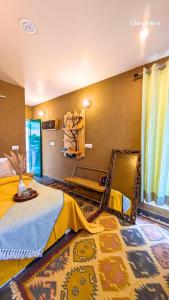 a bedroom with a bed with a yellow blanket on it at Shoonya x Aranya Agosh - Letibunga Mukteshwar in Mukteswar